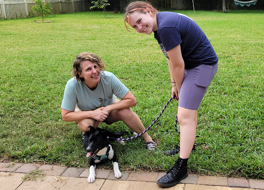 Adopter with her daughter and their new puppy